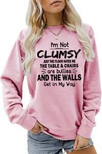 Detail of pink crewneck sweatshirt featuring black humorous text print for women