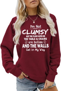 Detail of burgundy oversized sweatshirt with round neck and white text graphic print