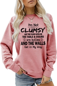 Close-up of artistic black letter print on rose pink round neck long sleeve sweatshirt