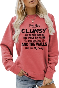 Close-up of crewneck sweatshirt with ribbed cuffs and I'm Not Clumsy humorous quote print