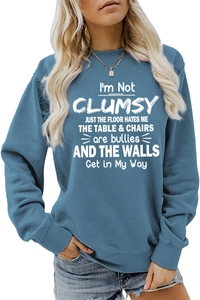 Detail of blue crewneck sweatshirt featuring white typography print and soft fabric texture