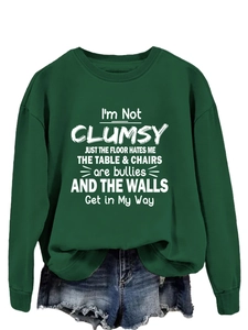 Detail of dark green crewneck sweatshirt with I'm Not Clumsy slogan print