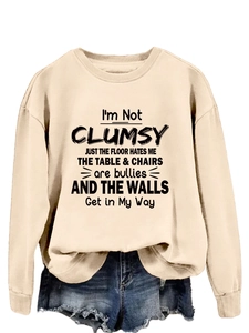 Detail of the funny graphic slogan print on a cream crew neck long sleeve sweatshirt