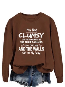 Close-up of funny quote print on brown cotton crewneck sweatshirt with ribbed cuffs