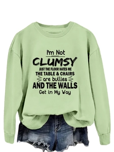 Detail of light green sweatshirt ribbed cuffs and humorous typography print design