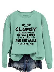 Detail of mint green long sleeve sweatshirt with black humorous graphic text print