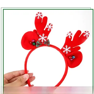 Detail of Christmas reindeer antler headband with festive bells and plaid bow decoration