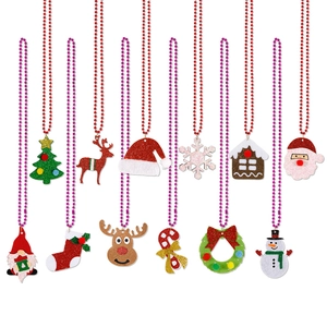 Detail of Christmas beaded necklaces with reindeer and tree pendants for party favors