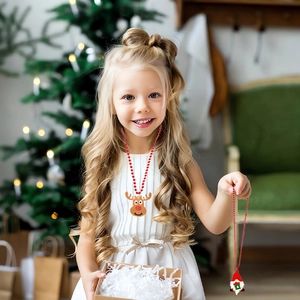 Detail of red beaded Christmas necklace with cute Santa and reindeer cartoon pendants
