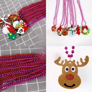 Close-up of festive Christmas beaded necklaces with felt Santa and reindeer pendants