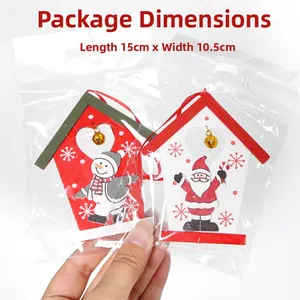 Close-up of Christmas wooden house ornaments with santa and snowman motifs in packaging