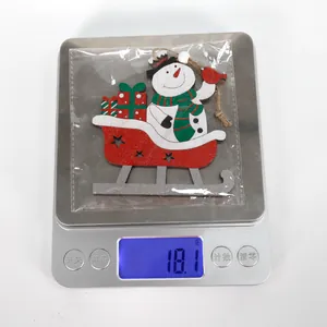 Detail showing wooden snowman sleigh ornament weight of 18.1g on a digital scale