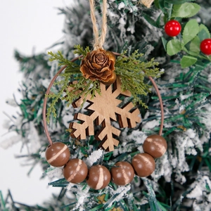 Rustic Christmas wreath with wooden snowflakes, pine cones, and beads on a snowy tree