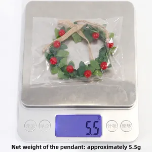 Close-up of mini Christmas wreath pendant with red berries weighing approximately 4.5g