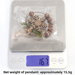 Macro shot of a wooden snowflake hanging ornament on a scale showing 15.5g weight