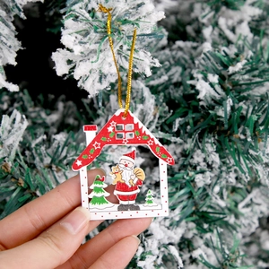 Handheld wooden Christmas house ornament featuring Santa Claus on a snowy tree background