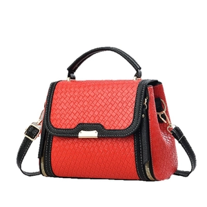 Red and black woven fashion handbag with gold hardware and top handle shown on white background
