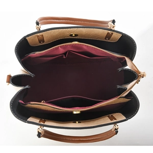 Top view of color-block tote bag showing multi-compartment interior and gold hardware