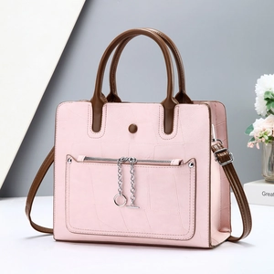Pink textured leather tote bag with dark brown handles and silver chain detail