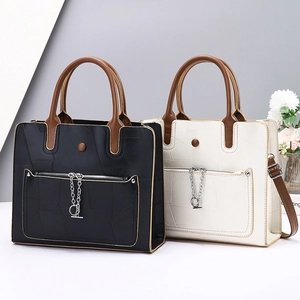 Detail of high-capacity tote bags with lychee grain texture and metal chain ring decor