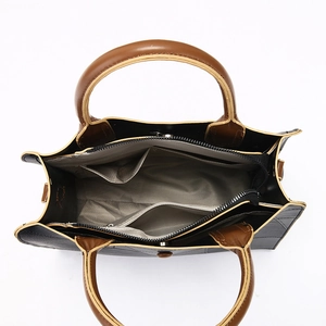 Interior view of bicolor tote bag showing zippered compartment and herringbone lining