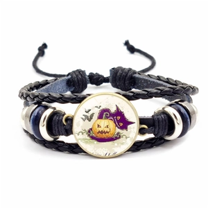 Detail of Halloween braided bracelet featuring a pumpkin motif and adjustable cords