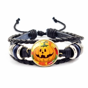 Detailed view of Halloween Jack-o'-lantern illustration in multi-layer woven bracelet