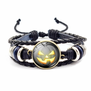Halloween woven leather bracelet with luminous pumpkin glass charm and metal accents