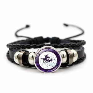 Detail of woven leather Halloween bracelet featuring a witch on broomstick moon gem