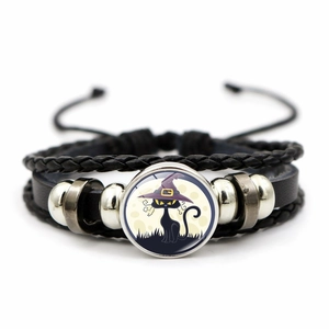 Detailed view of Halloween woven bracelet with black cat pendant and metal beads