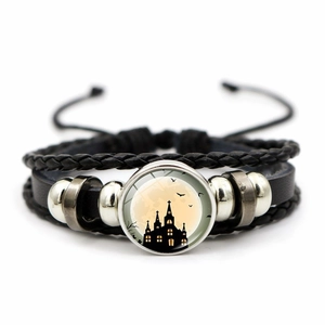 Detail of woven leather bracelet with Gothic castle moon charm and metal beads
