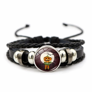 Detail of multi-layer woven Halloween bracelet with moonlit pumpkin glass gemstone