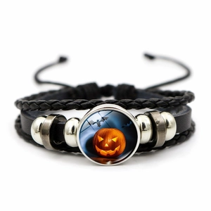 Detailed view of multilayer woven leather bracelet with Halloween pumpkin glass gem
