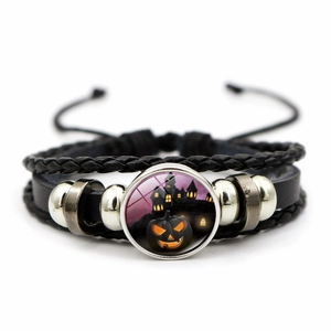 Detail of Halloween braided leather bracelet with pumpkin glass cabochon charm