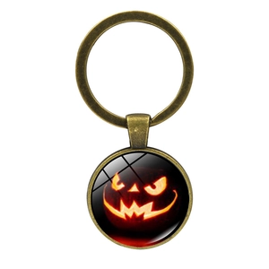 Detail of vintage bronze keychain with Jack-o'-lantern glass cabochon pendant