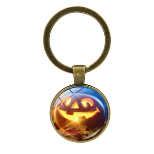 Detailed view of Halloween pumpkin jack-o-lantern glass cabochon in bronze keychain