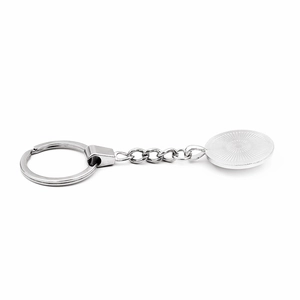 Silver metal keychain with sunburst sunray pattern round pendant on white background