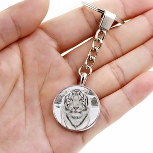 Handheld silver key ring featuring a realistic white tiger face glass cabochon pendant