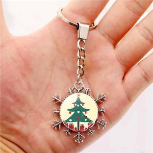 Christmas snowflake keychain with festive holiday tree and red gift box design pendant