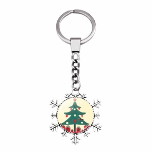 Macro detail of snowflake keychain featuring a festive Christmas tree pattern inlay