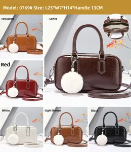 Detail view of stylish doctor style handbags with plush ball charm in six colors