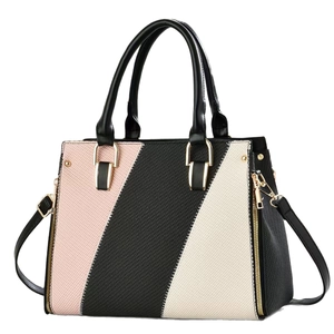 Three-tone patchwork leather handbag with gold accents and a crossbody strap on white background