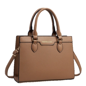 Elegant brown pebbled leather tote bag with gold hardware and detachable shoulder strap