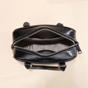 Overhead shot of the black bowling bag's interior with grey lining and zippered closure