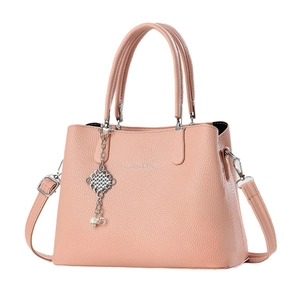 Elegant dusty pink lychee texture handbag with top handles and pearl charm accessory
