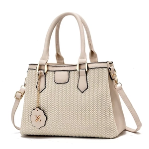 Elegant beige tote bag with V-shaped woven texture and gold hardware for women