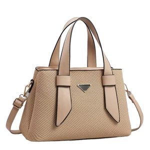Women's straw and leather tote bag with contrast stitching and golden hardware accents