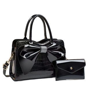 Glossy black patent leather handbag set with rhinestone bow and crocodile texture