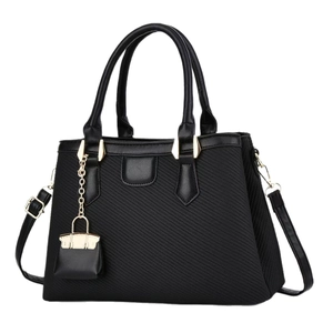 Fashionable black macaron handbag with crossbody strap and gold chain charm detail