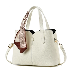 Elegant cream lychee leather handbag with silk scarf and gold hardware in professional view